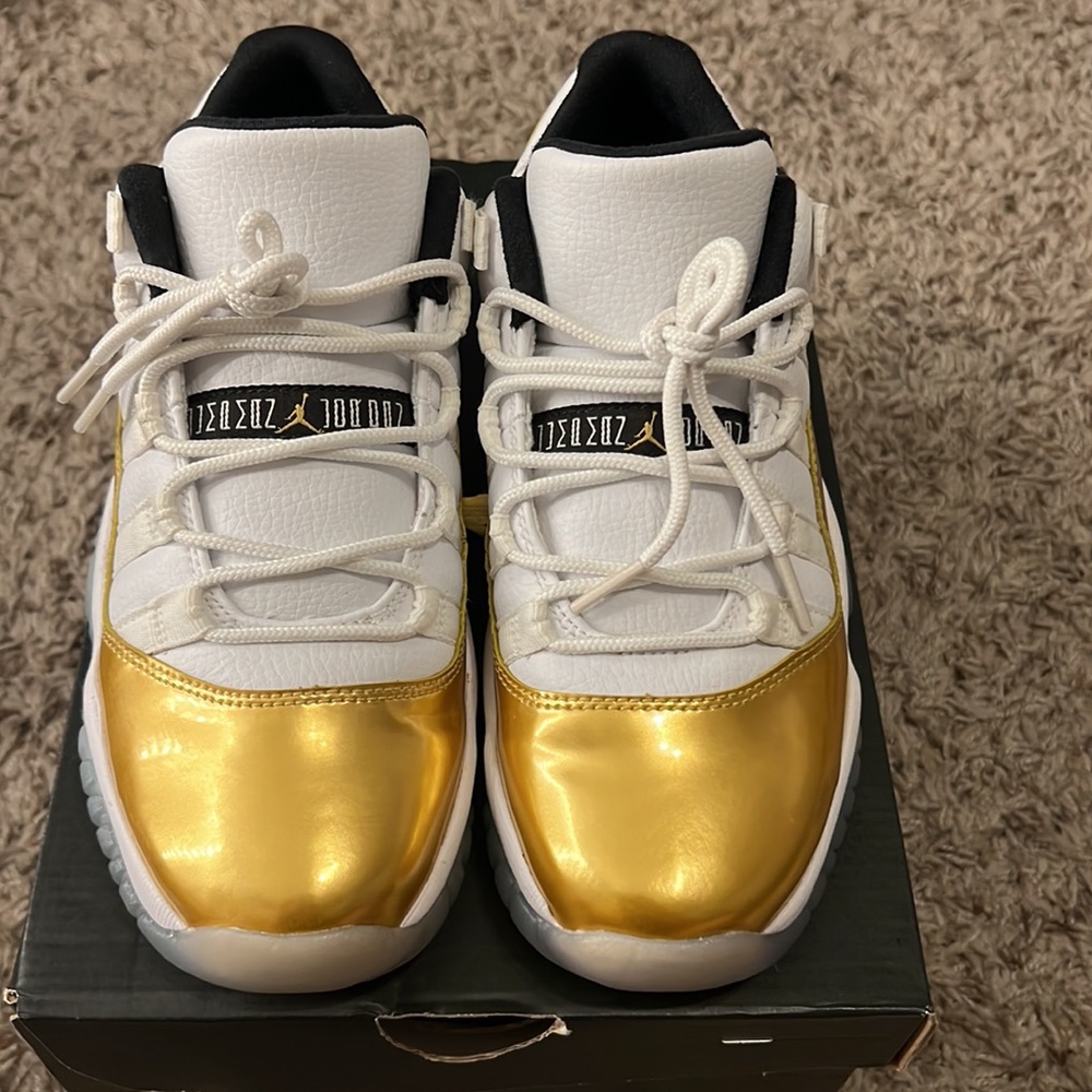 gold & white jordan low top 11s